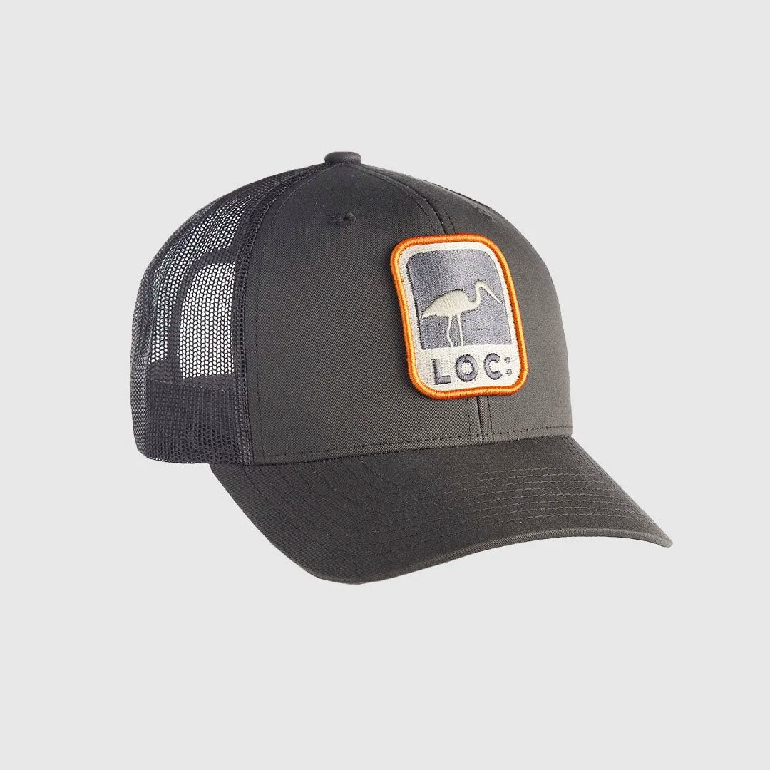 A dark gray trucker hat with a mesh back and a front patch featuring a LOC logo and the text 'LOC'.