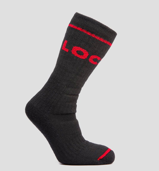 A black LOC merino wool sock with red accents and the brand name 'LOC' in white letters across the cuff.