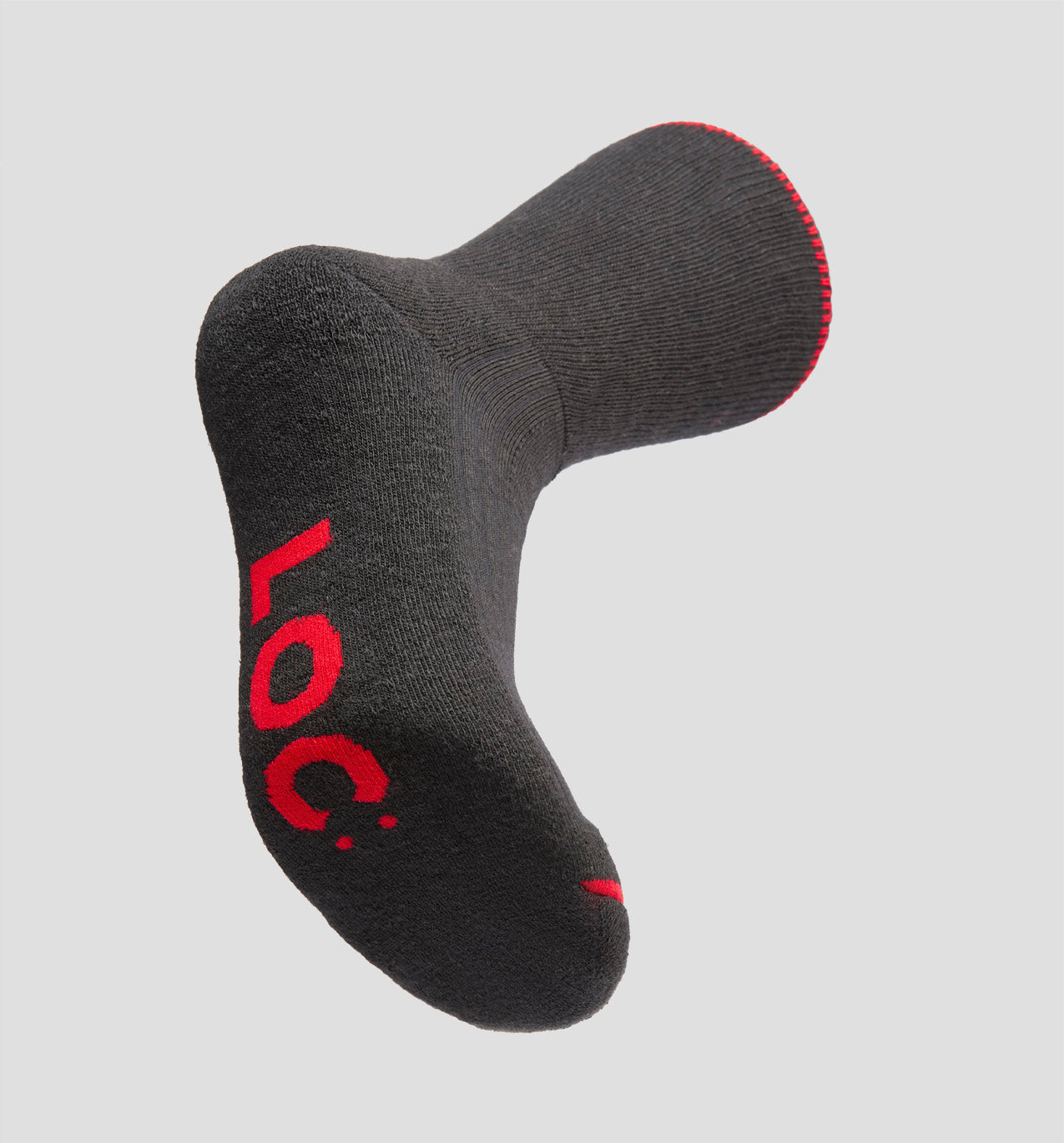 A black merino wool sock with red trim at the top edge, displaying the LOC brand logo under the sole.
